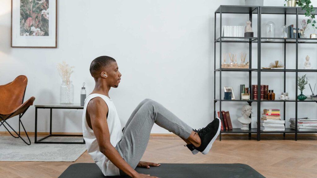 50 plus year old black man doing yoga mat exercises symbolising health & fitness and his empowering habits - wellness beyond 50