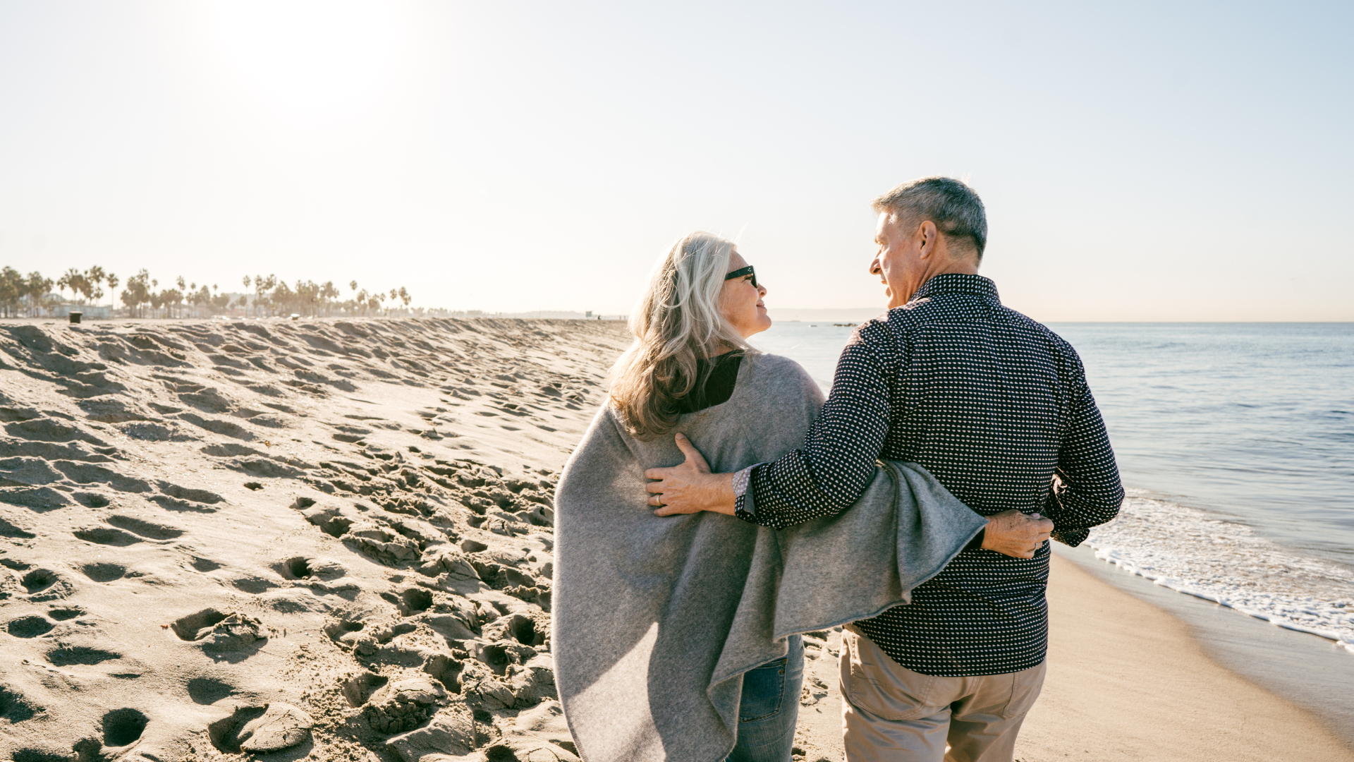 Happy Healthy Couple Walking By The Beach Hugging Each Other